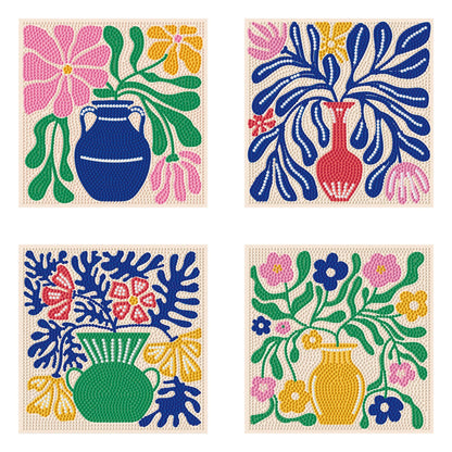 Four colorful, stylized illustrations of vases with large flowers and leaves, each in a different color—blue, red, green, or yellow—filled with vibrant floral designs. Finished using the Diamond Dotz Mini Dotz kit.
