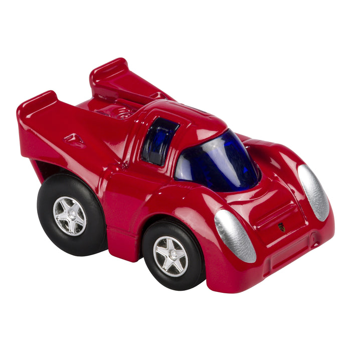 A Rollin' Mini Die Cast Car by Rollin', featuring a small red body, black wheels, silver headlights, and a blue-tinted windshield, is shown from a front-side angle on a white background.