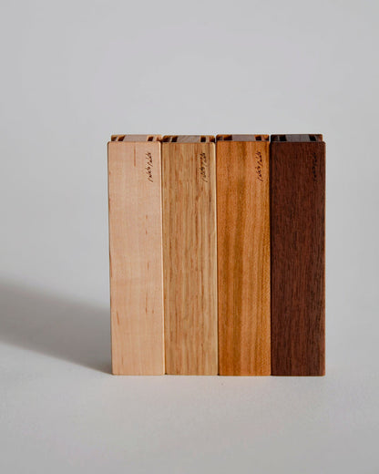 Wooden toothpick cases by Nalata Nalata and Tanno on a gray backdrop