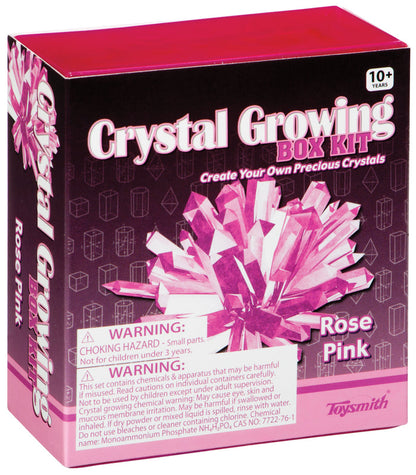 A pink box labeled Toysmith Crystal Growing Kit for ages 10+, featuring pink crystals. This Rose Pink DIY science kit by Toysmith includes safety warnings about small parts and chemical hazards.